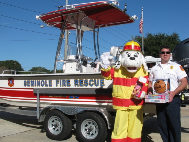 Pictured here are SPARKY the fire dog and Fire Lieutenant Lance Volpe of City of Seminole Fire Rescue receiving the first donations.