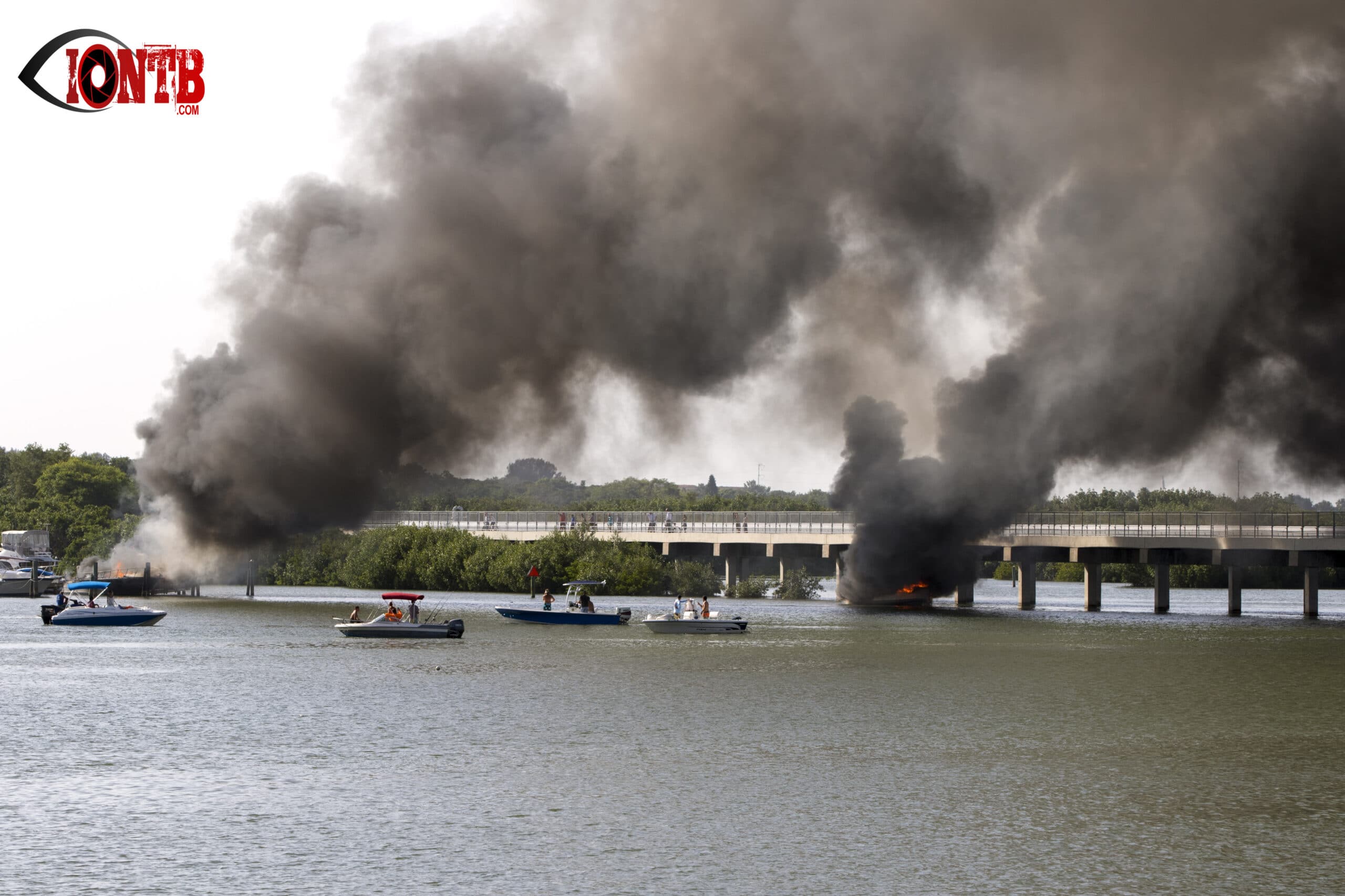 Photo of three boats on fire at the Bay Pines Marina