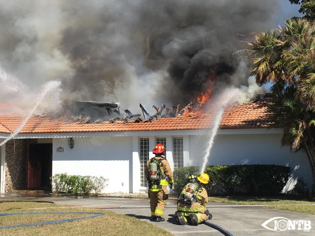 Firefighters from Seminole Fire Rescue using a handline to fight the fire safely from the exterior